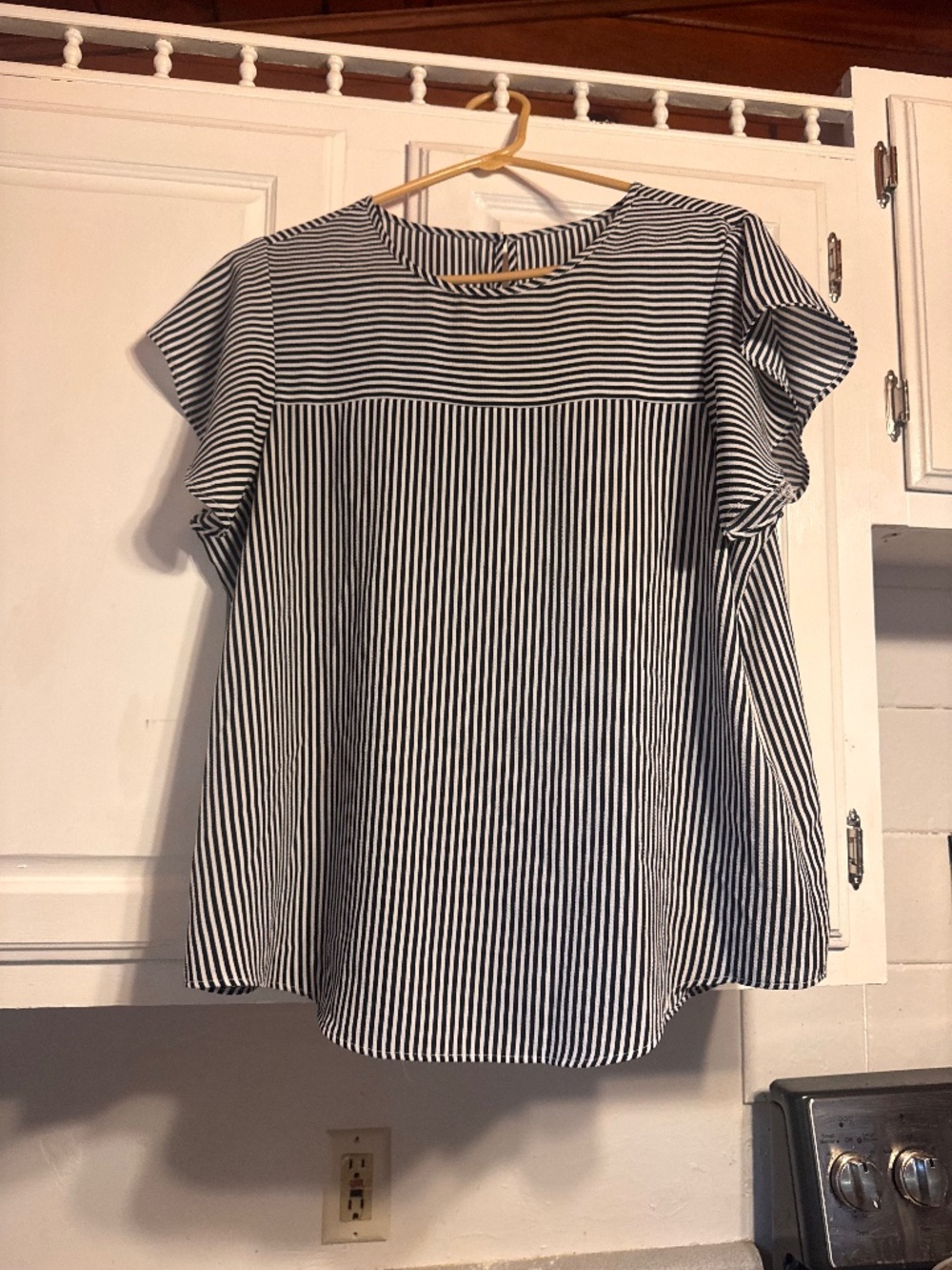 A classic black and white striped blouse with a relaxed, flattering silhouette.